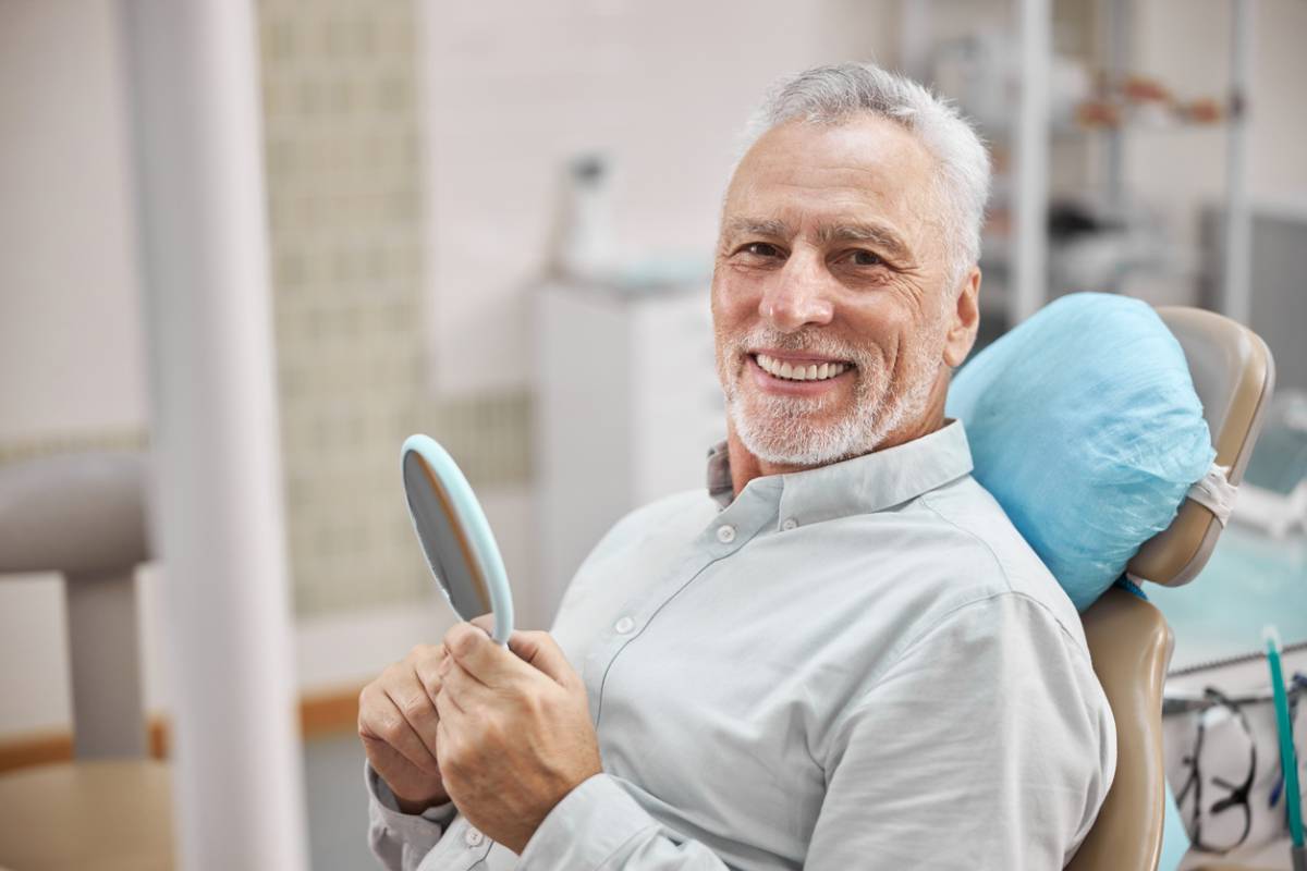 Man smiling about crazy oral health statistics.